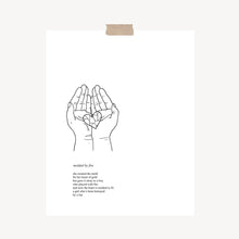 Load image into Gallery viewer, An art print featuring a poem called, “Molded By Fire” with original artwork of two hands together holding a broken heart pieced back together hung with a piece of kraft tape on the top.
