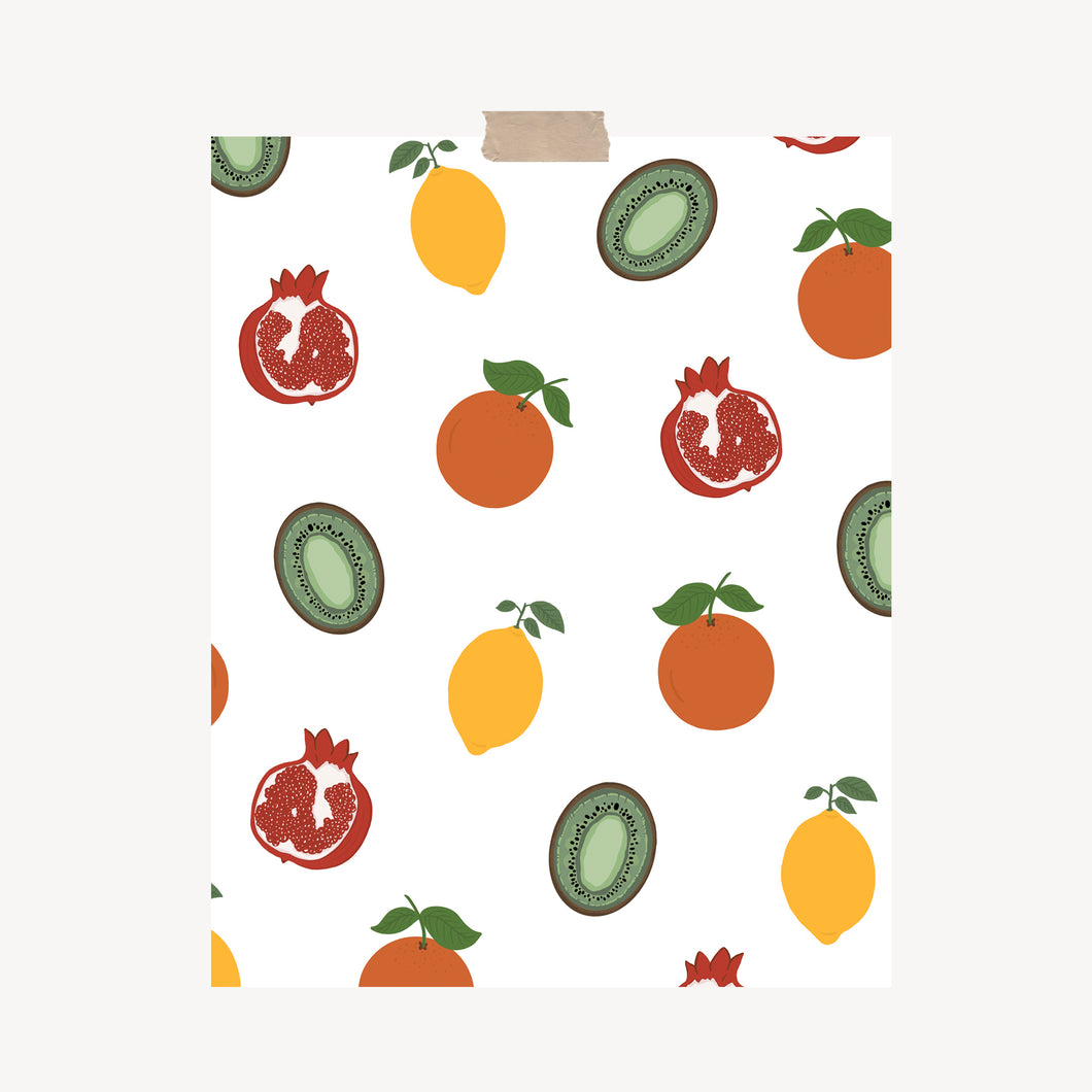 An art print featuring scattered fruits, including an orange, pomegranate, kiwi, and lemon hung with a piece of kraft tape on the top.