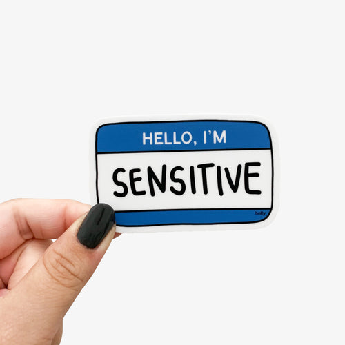 A funny sticker featuring a blue name tag and text that reads, Hello, I’m Sensitive.