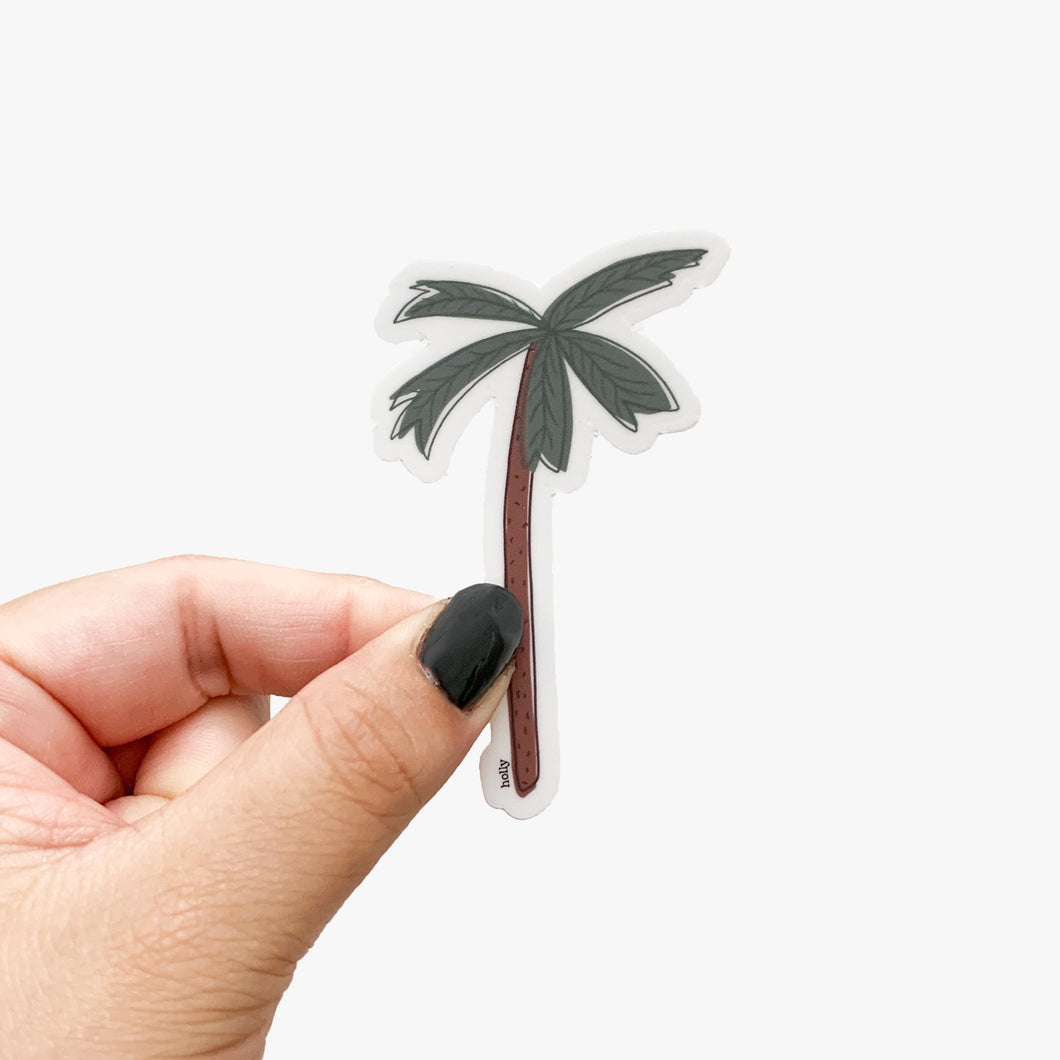 A sticker featuring a palm tree with an uneven outline.