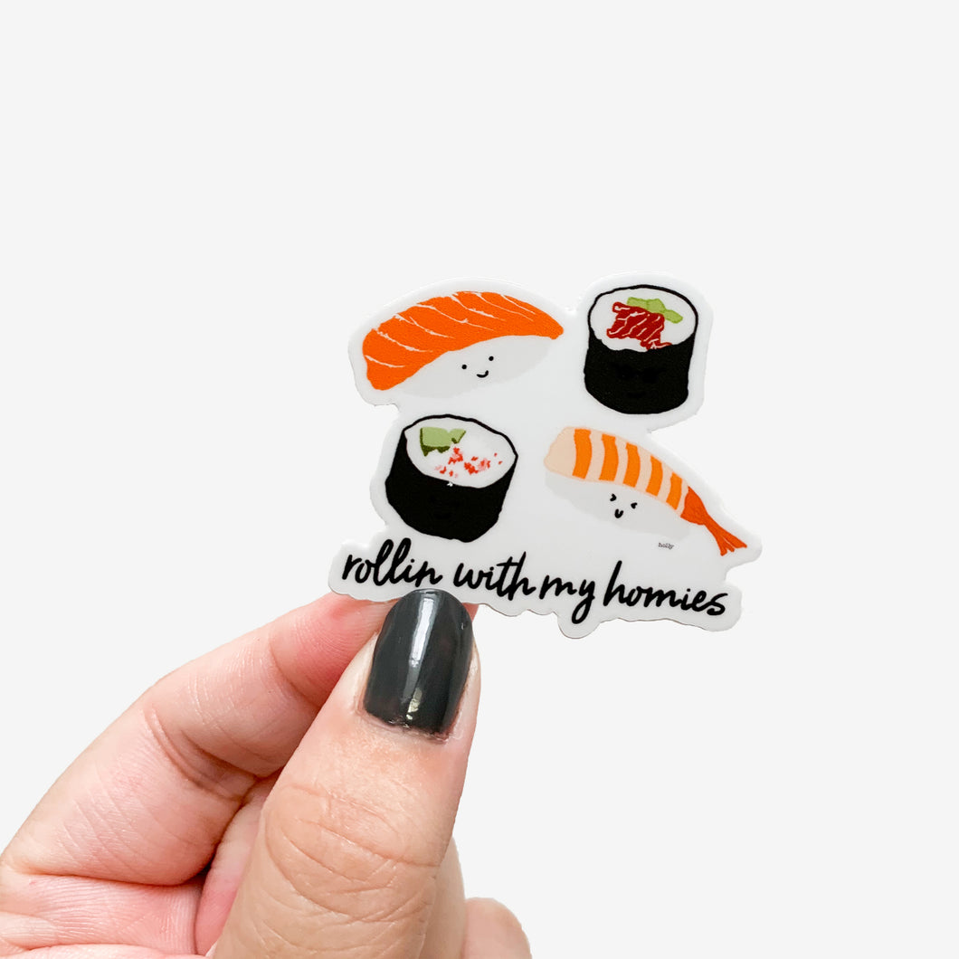 A sticker featuring two nigiri and two sushi rolls and text that reads, Rollin with my homies.