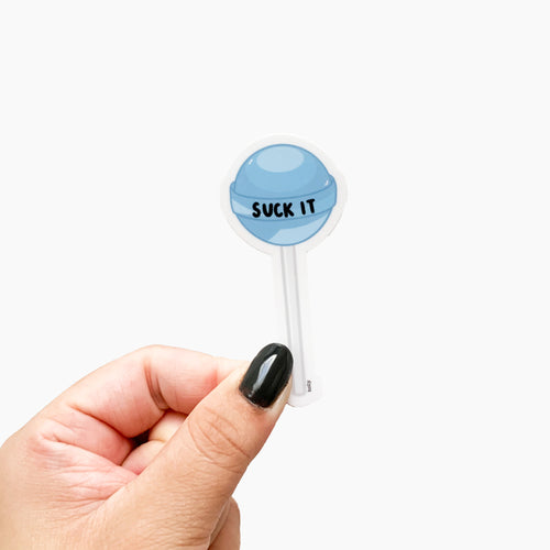 A funny sticker featuring a blue lollipop and text that reads, Suck It.