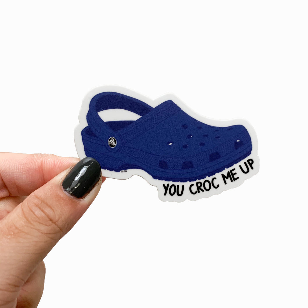 A funny sticker featuring blue crocs and text that reads, You croc me up.